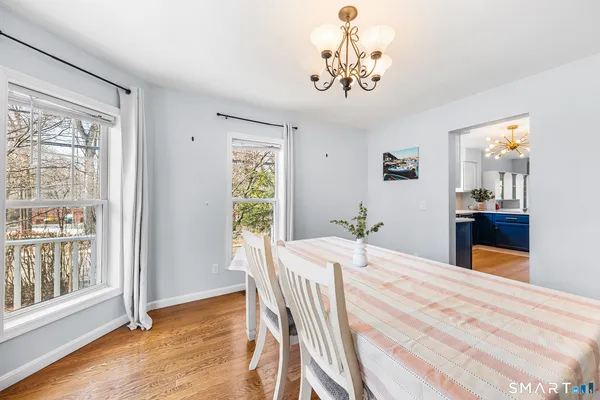 a view of a dining room with furniture window and wooden floor
