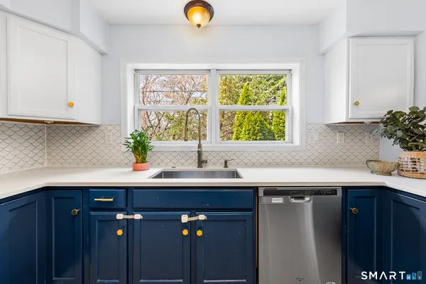 a kitchen with a sink and a window
