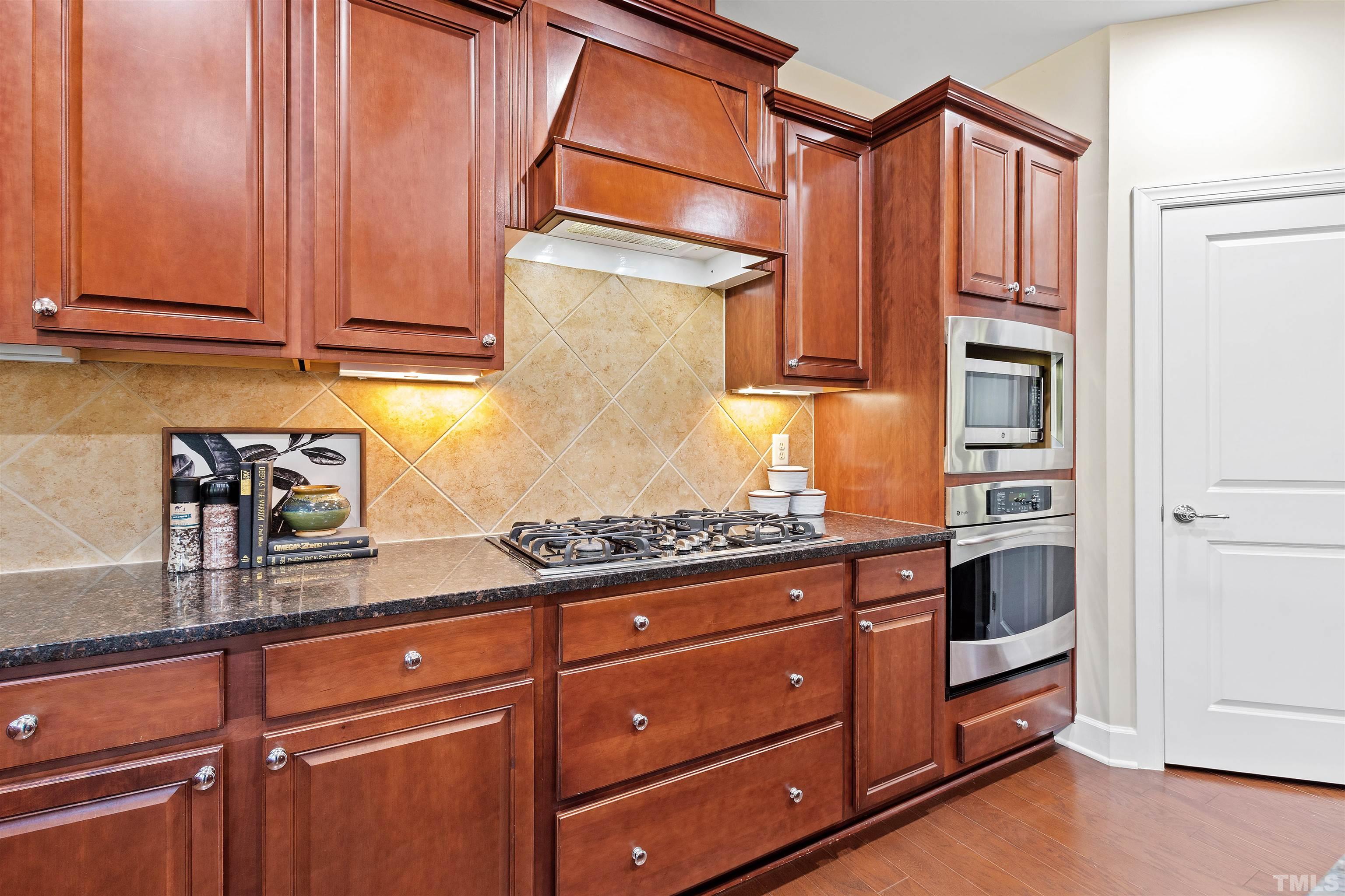 400 Alliance Circle Cary, NC 27519 - Photo 23 of 62 a kitchen with stainless steel appliances granite countertop a refrigerator and a stove