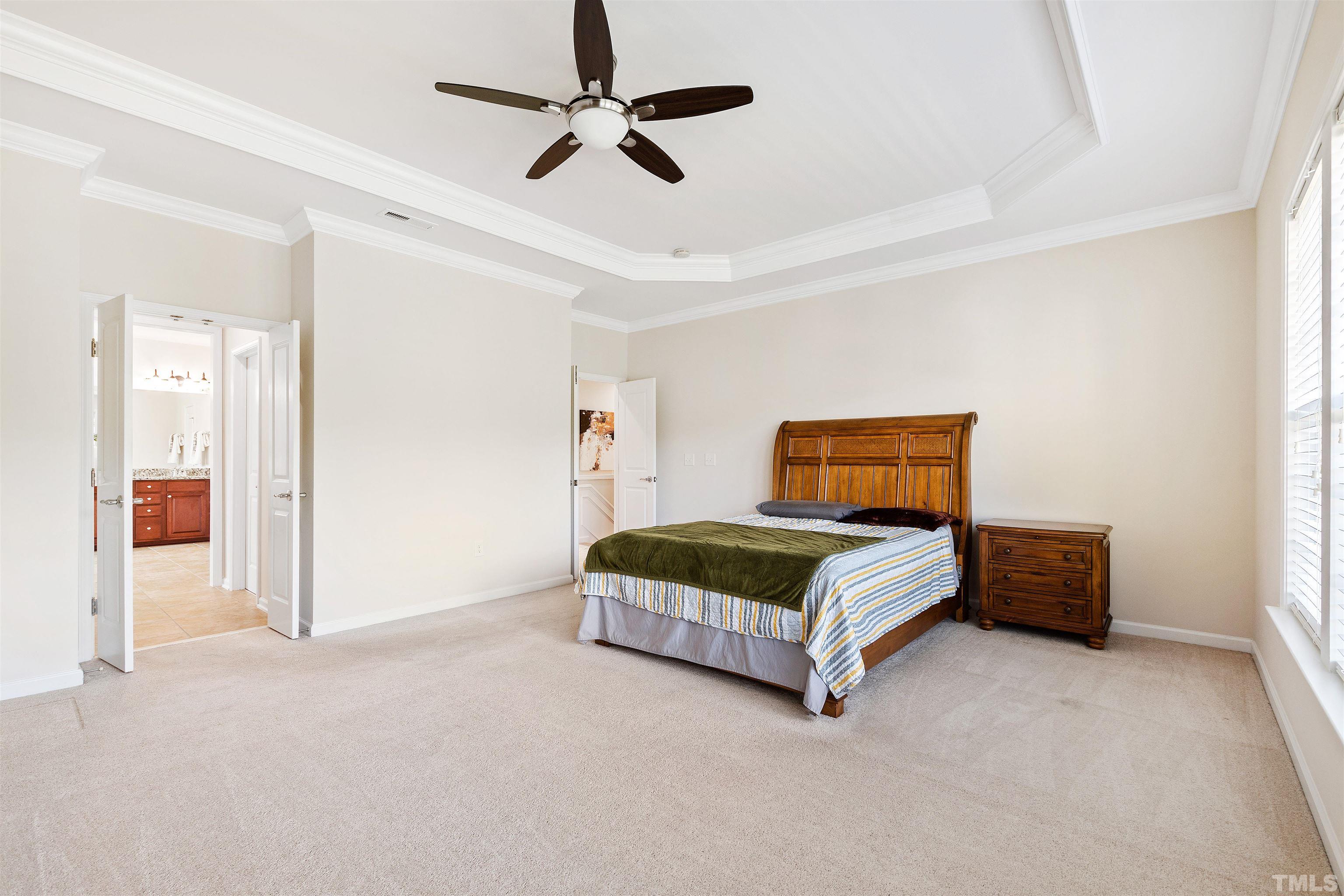 400 Alliance Circle Cary, NC 27519 - Photo 31 of 62 a bedroom with a bed and a chandelier