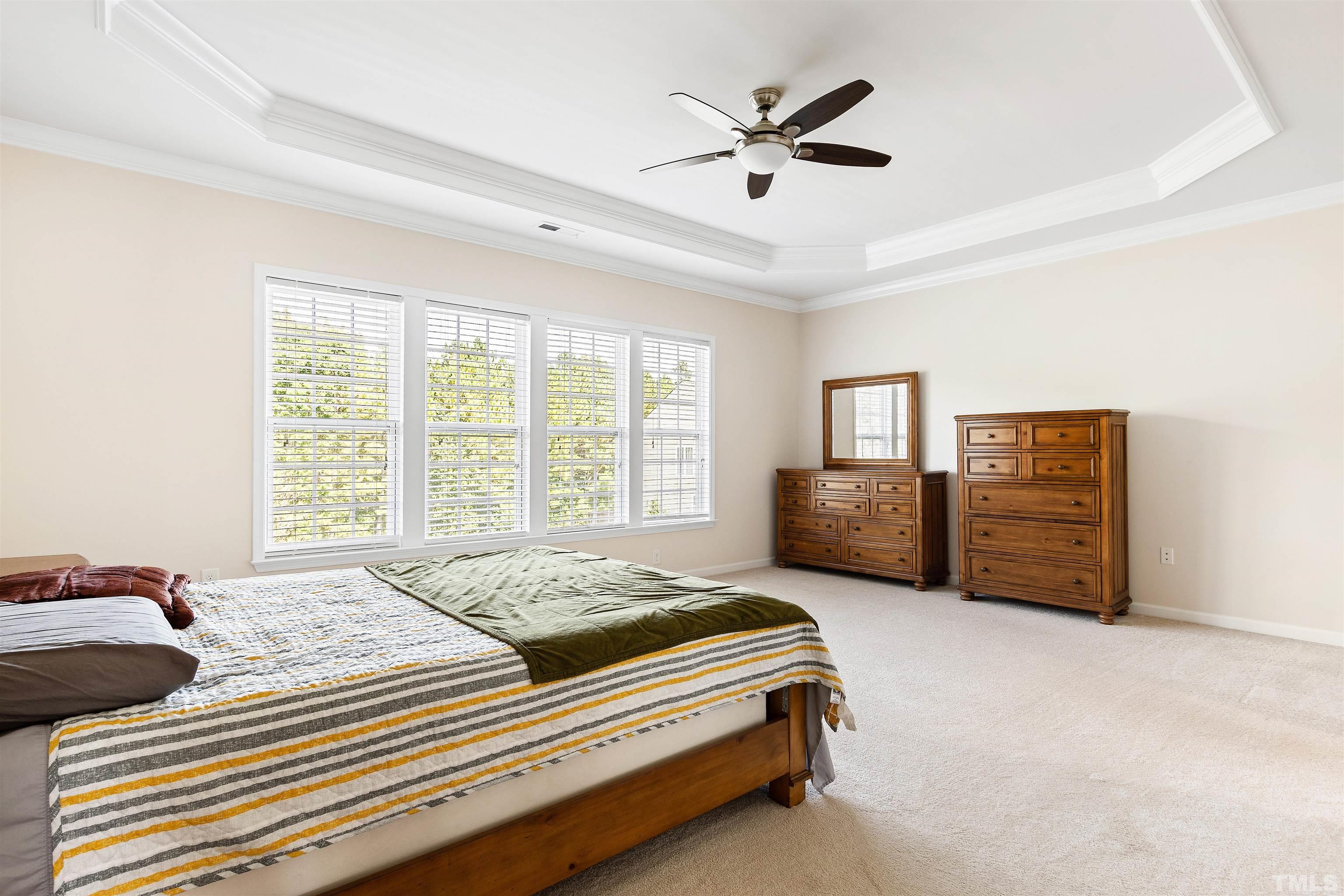 400 Alliance Circle Cary, NC 27519 - Photo 32 of 62 a spacious bedroom with a bed a couch and a large window