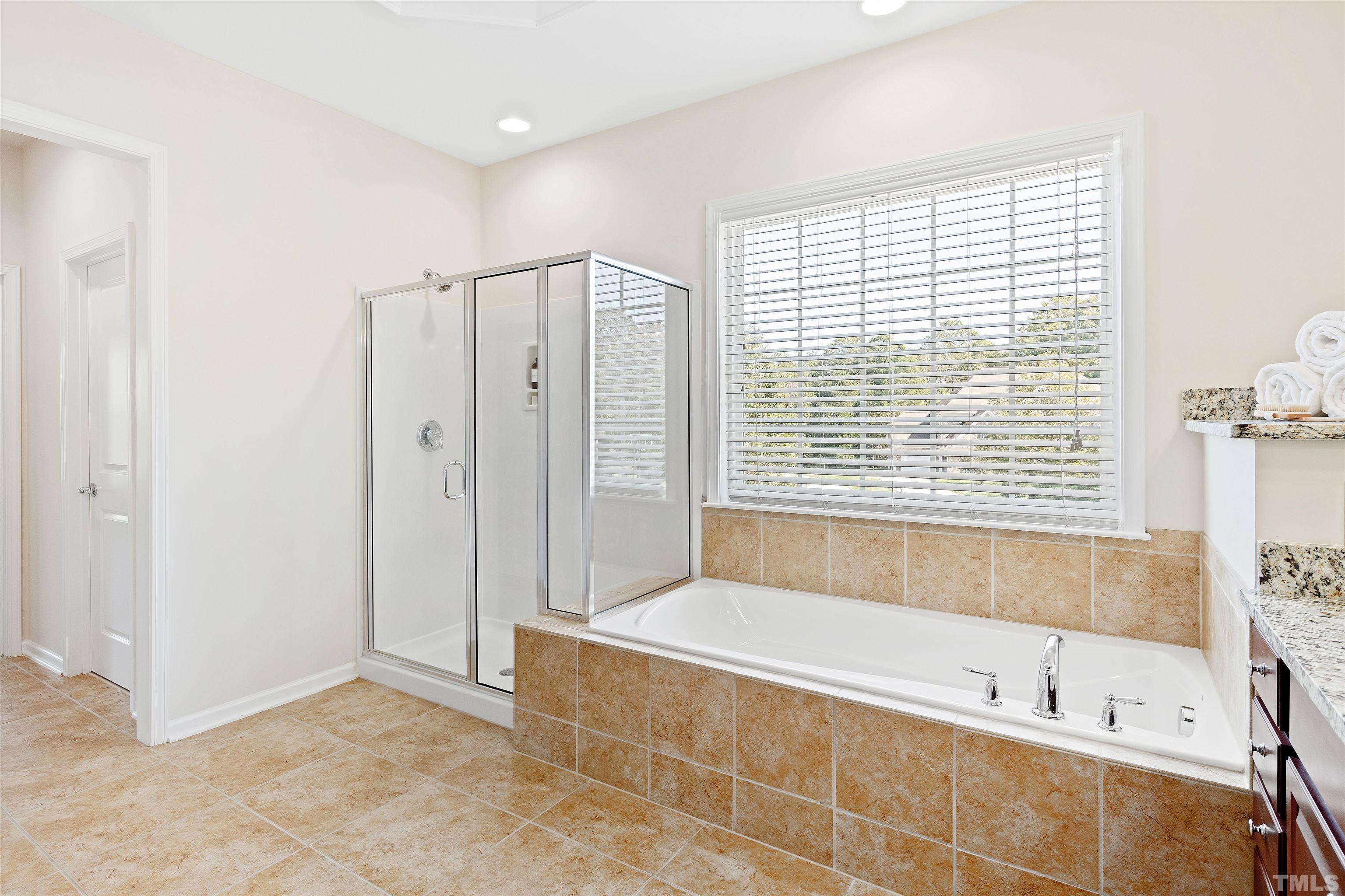 400 Alliance Circle Cary, NC 27519 - Photo 34 of 62 a bathroom with a bathtub and a shower