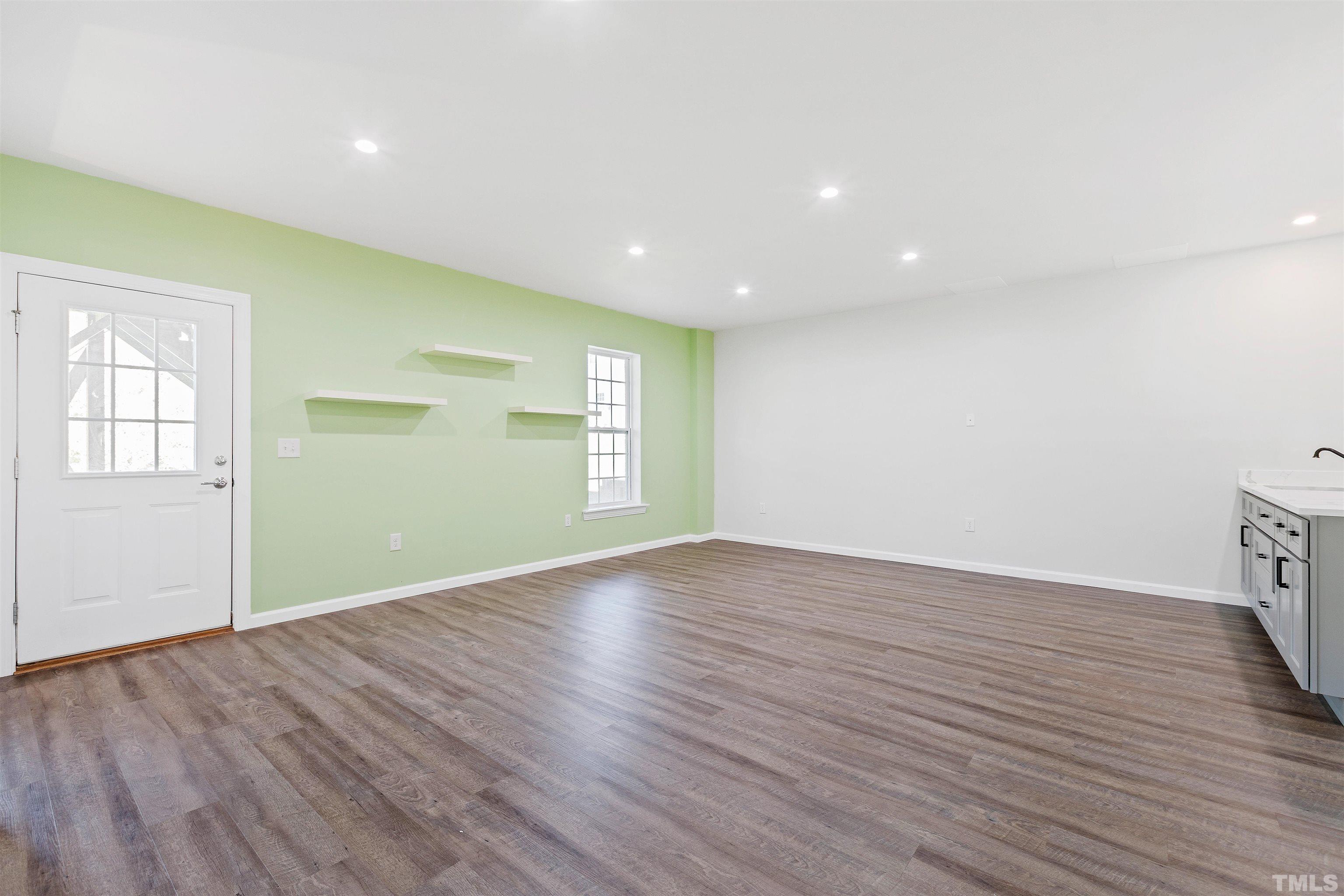 400 Alliance Circle Cary, NC 27519 - Photo 48 of 62 an empty room with wooden floor and windows