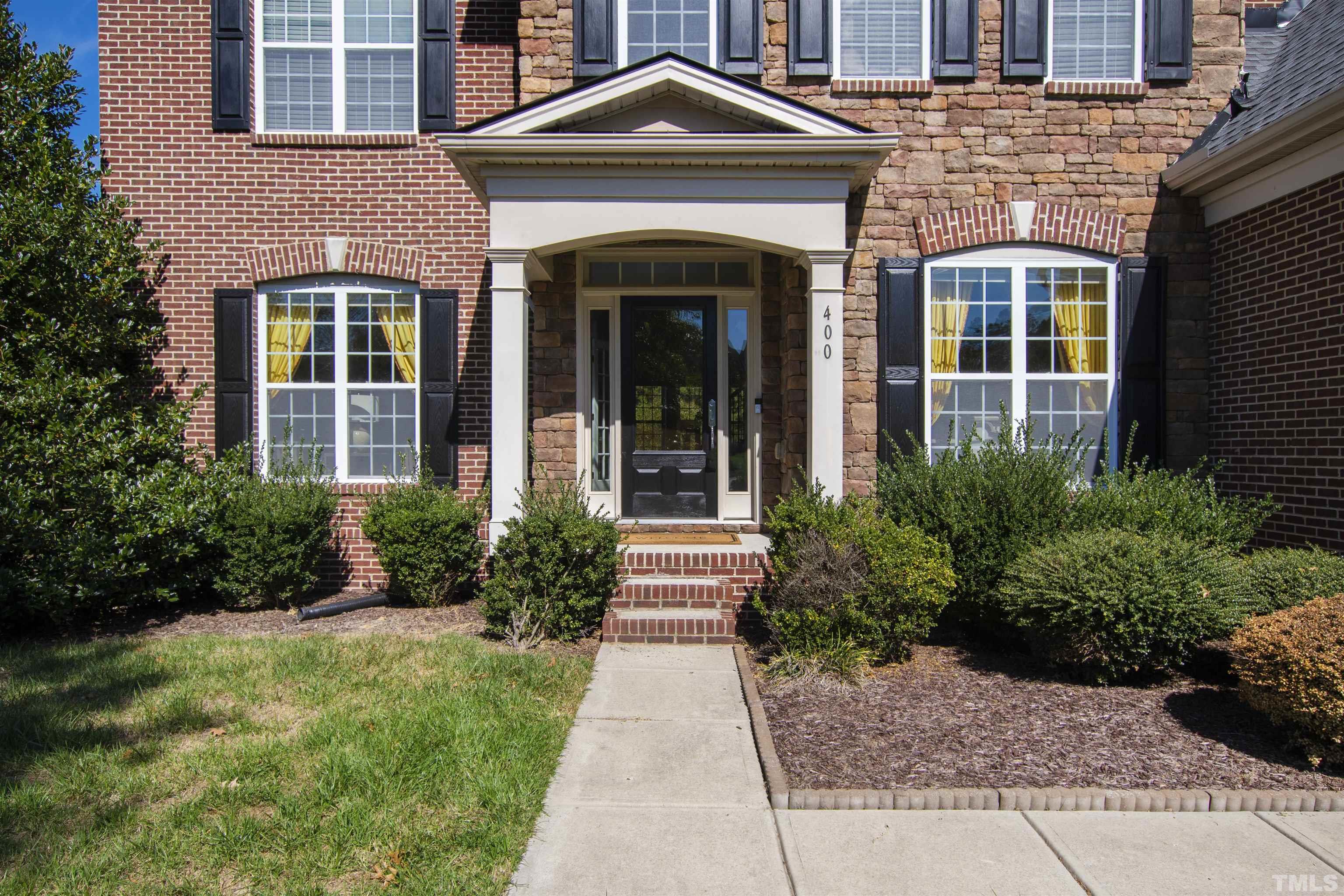 400 Alliance Circle Cary, NC 27519 - Photo 57 of 62 a front view of a house with garden