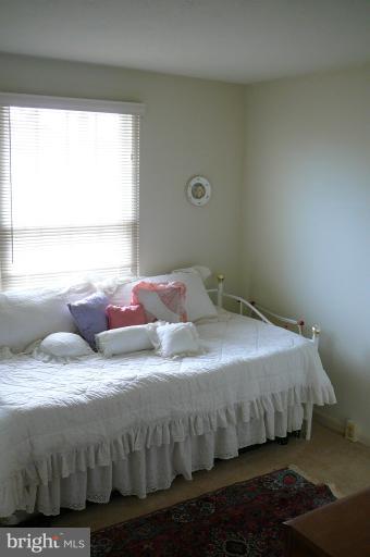 a bedroom with a bed with a window