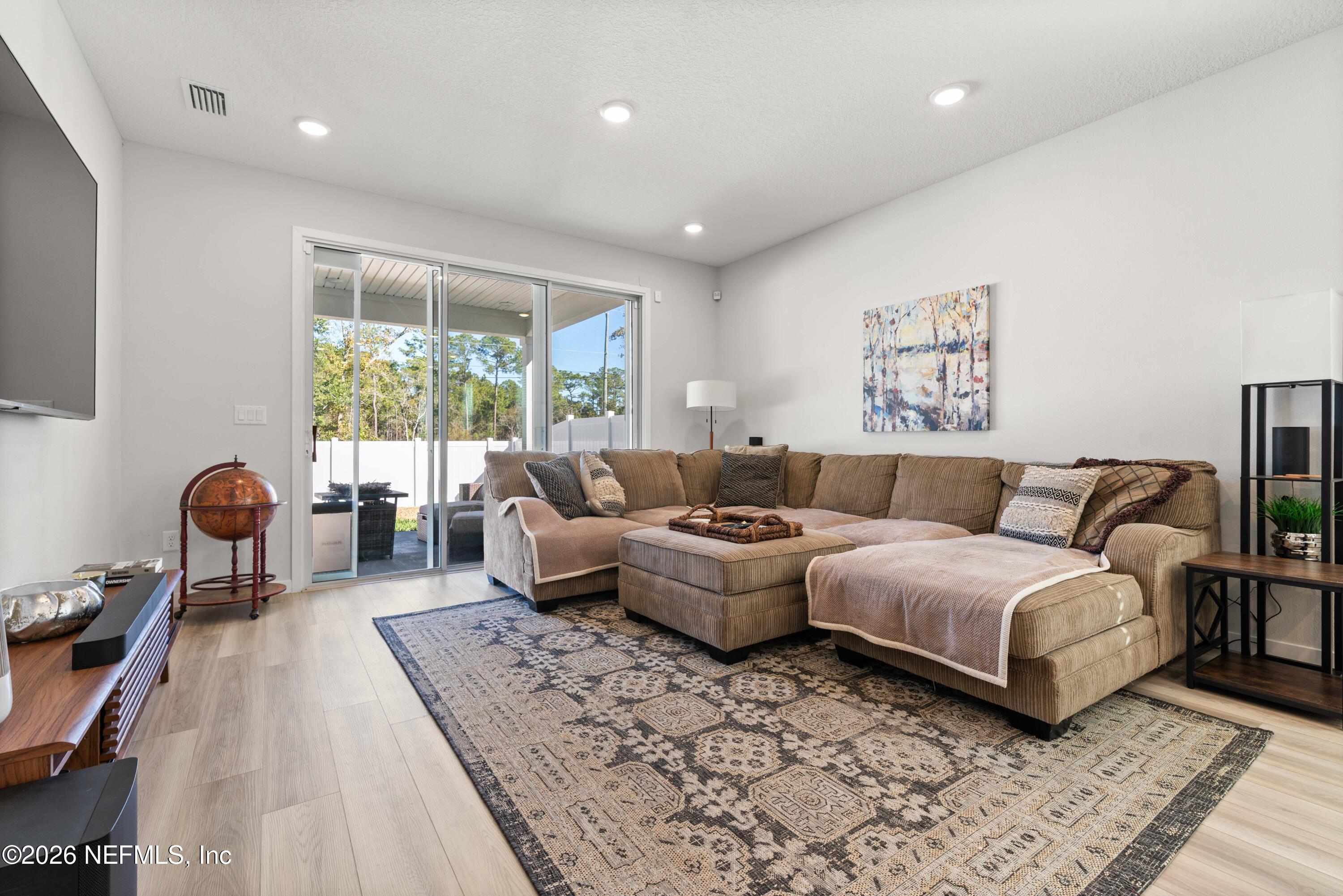 96245 Broadmoore Road Fernandina Beach, FL 32034 - Photo 13 of 33 a living room with furniture and a large window