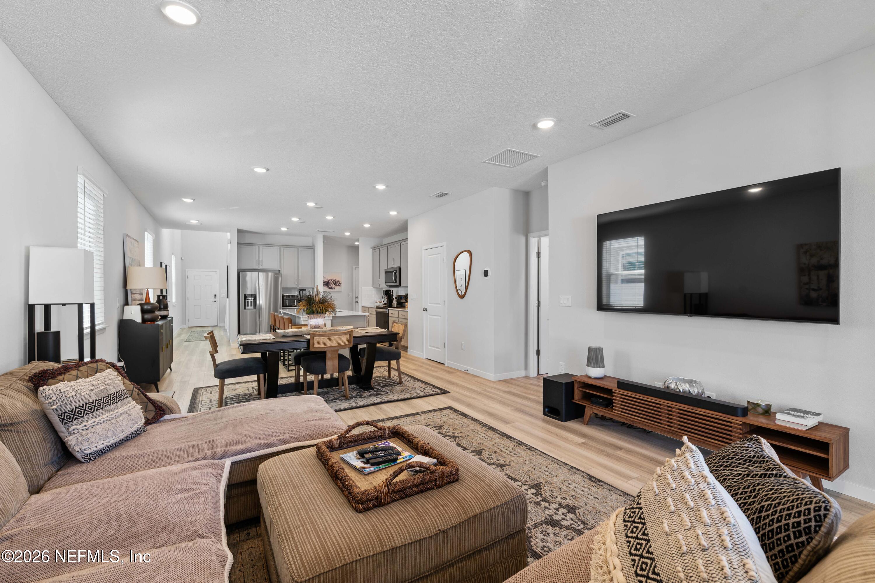 96245 Broadmoore Road Fernandina Beach, FL 32034 - Photo 14 of 33 a living room with furniture and a flat screen tv