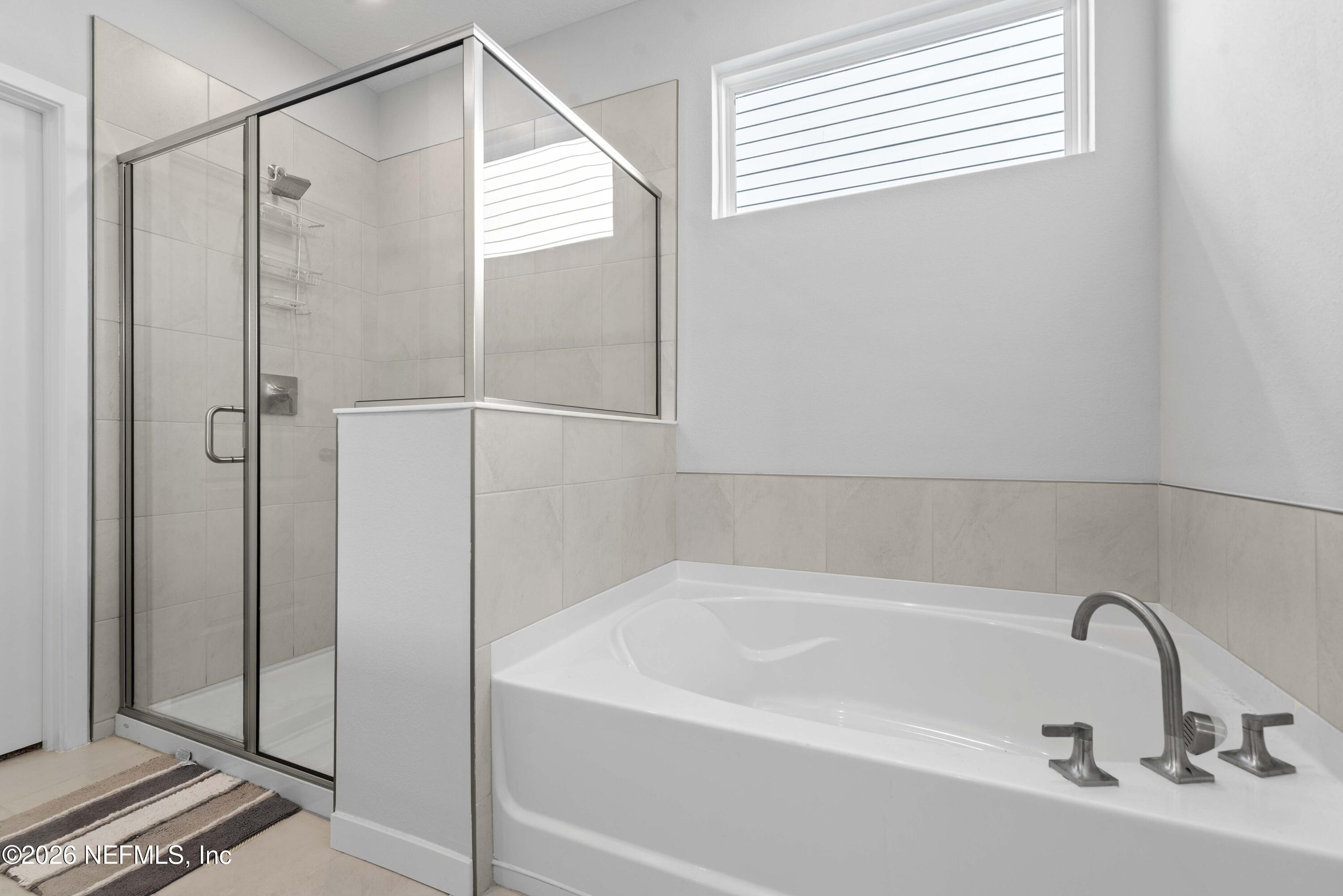 96245 Broadmoore Road Fernandina Beach, FL 32034 - Photo 18 of 33 a bathroom with a bathtub and a shower