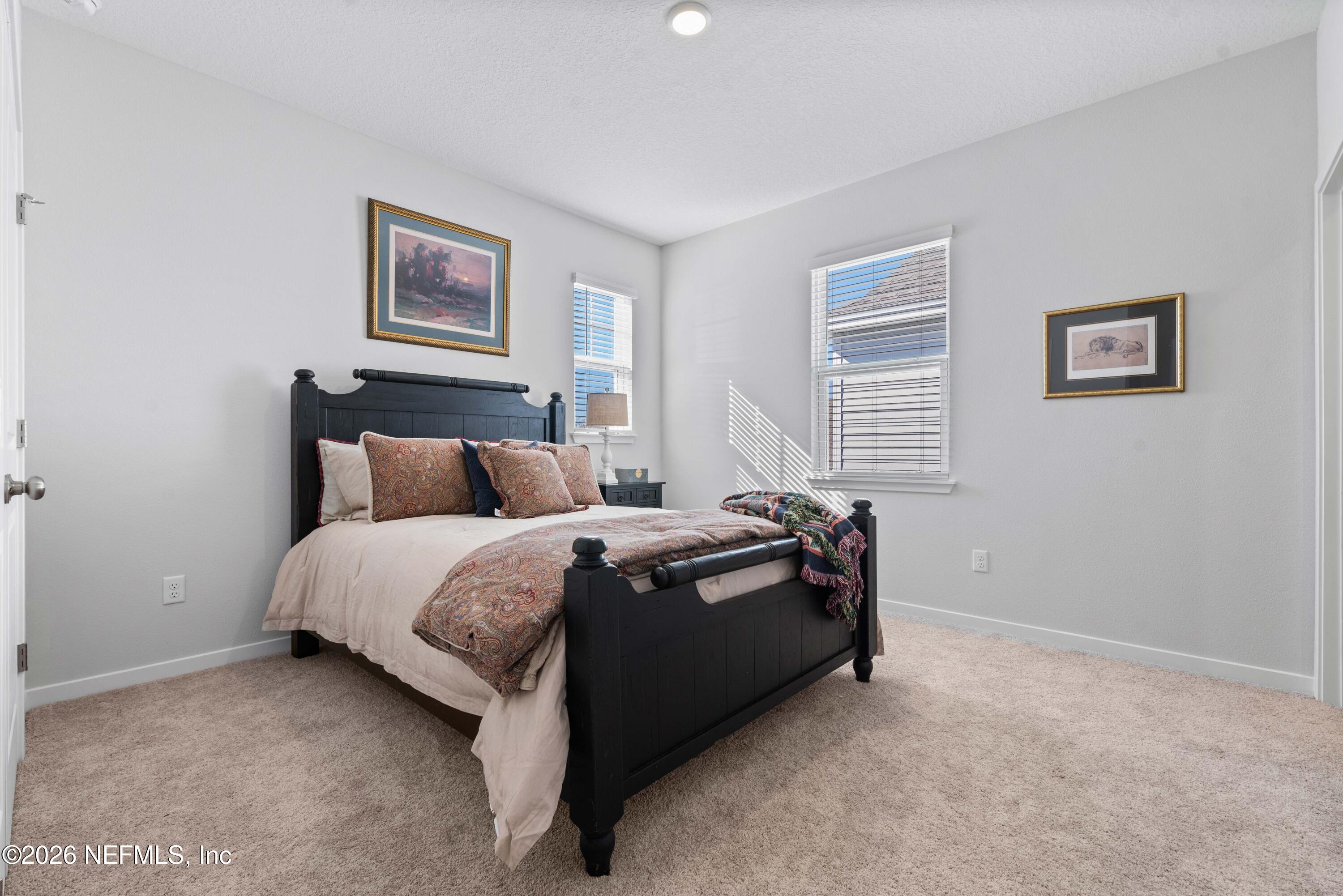 96245 Broadmoore Road Fernandina Beach, FL 32034 - Photo 22 of 33 a bed sitting in a bedroom next to a window