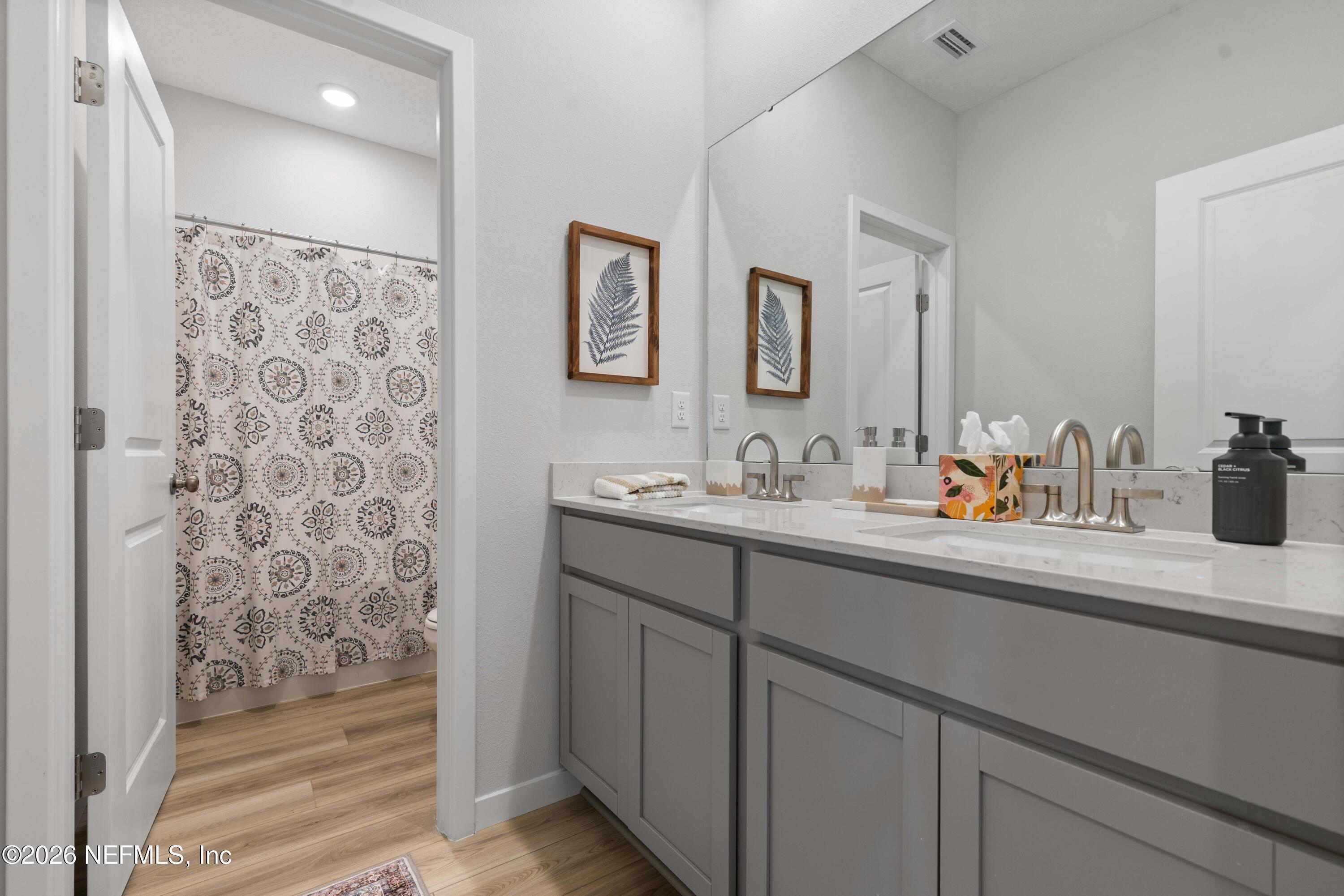96245 Broadmoore Road Fernandina Beach, FL 32034 - Photo 25 of 33 a bathroom with a sink a mirror and a shower