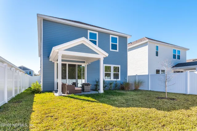 a view of a house with backyard and porch