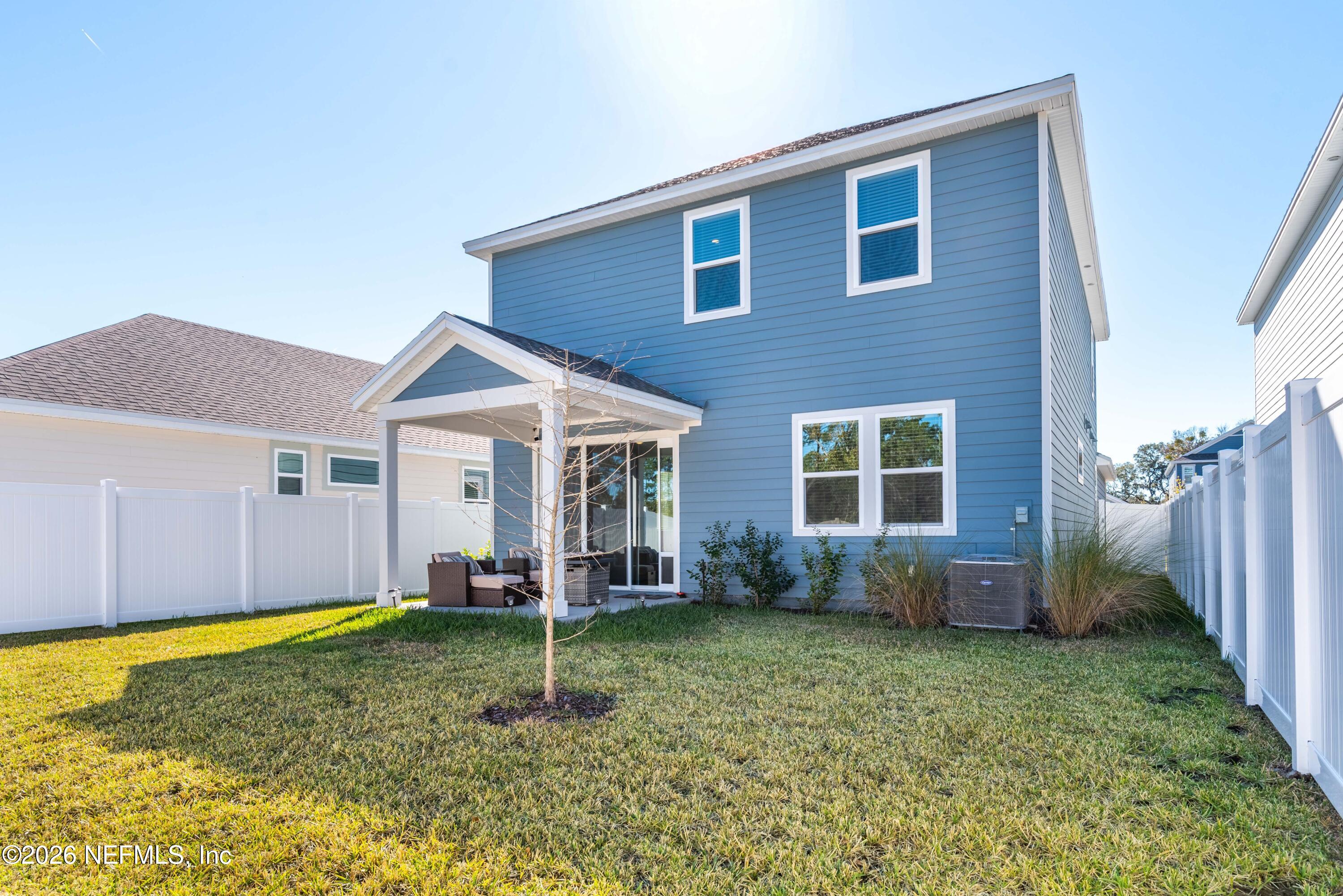 96245 Broadmoore Road Fernandina Beach, FL 32034 - Photo 33 of 33 a backyard of a house with wooden fence and a yard