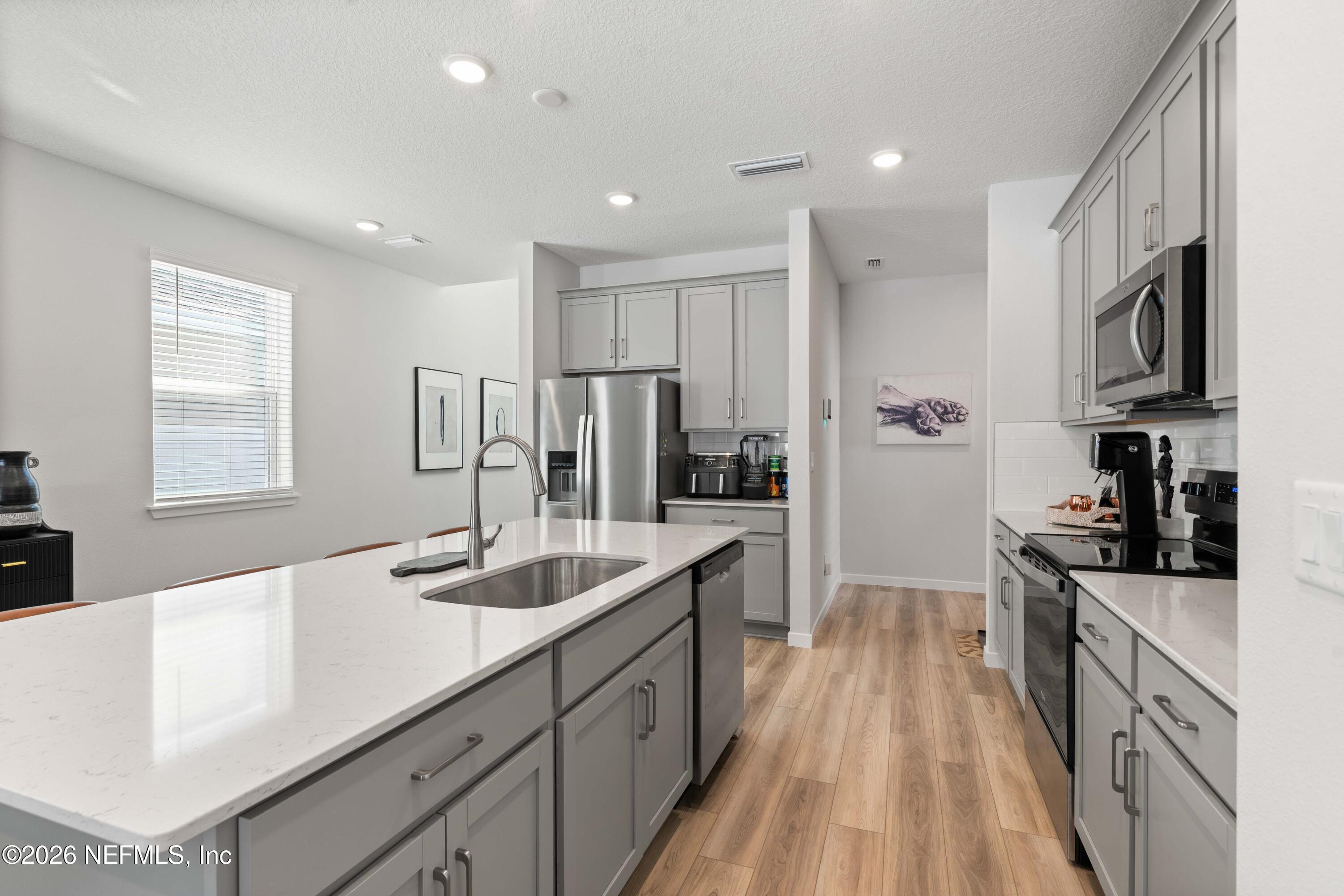 96245 Broadmoore Road Fernandina Beach, FL 32034 - Photo 9 of 33 a large kitchen with stainless steel appliances granite countertop a lot of counter space and a sink
