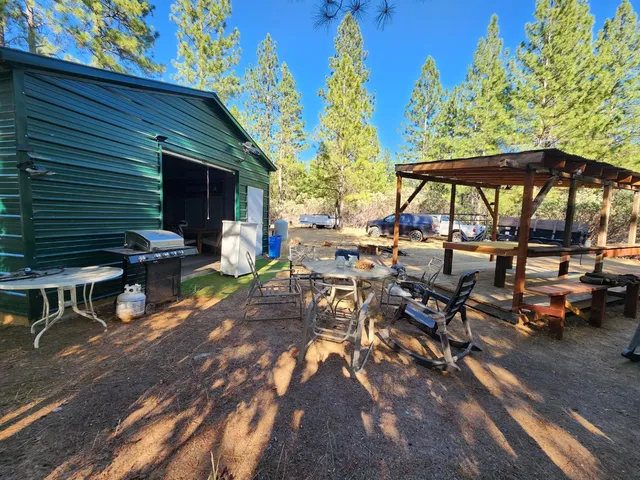 a view of a house with a yard chairs and a fire pit