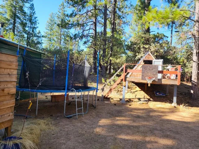 a view of a swimming pool with a yard and sitting area