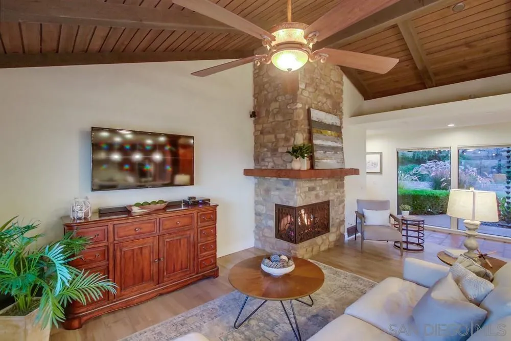 16062 Stoney Acres Road Poway, CA 92064 - Photo 38 of 75 a living room with furniture a fireplace and a flat screen tv