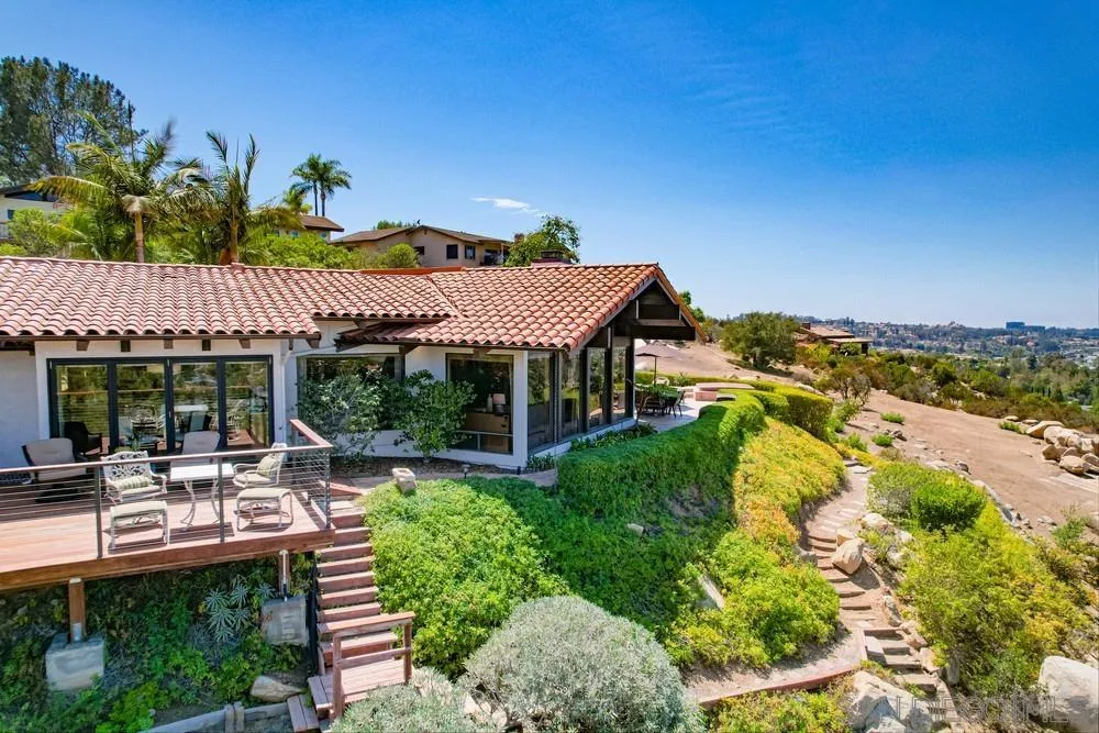 16062 Stoney Acres Road Poway, CA 92064 - Photo 64 of 75 a view of a patio with table and chairs under an umbrella next to a yard