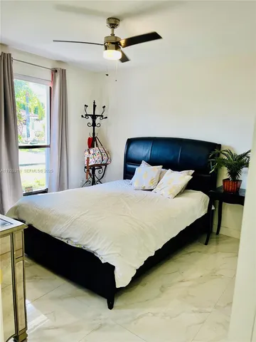 a bed sitting in a bedroom next to a window