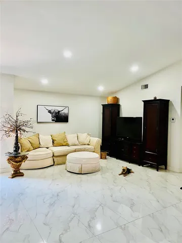 a living room with furniture and a lamp