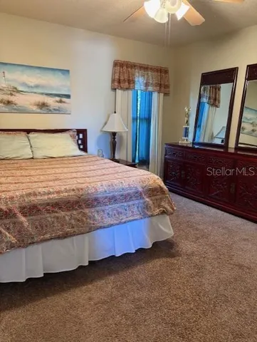 a bedroom with a bed and a mirror on dresser