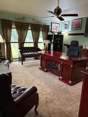 a living room with furniture a flat screen tv and gym equipment