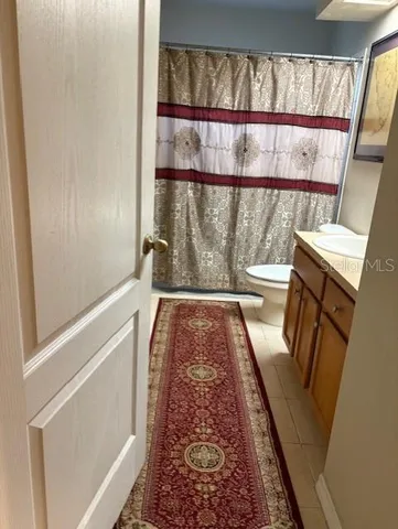 a living room with furniture and a mirror