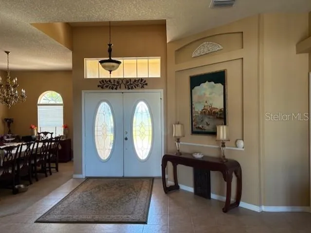 a living room with furniture and a mirror