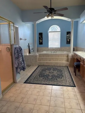 a bathroom with a tub sink and mirror