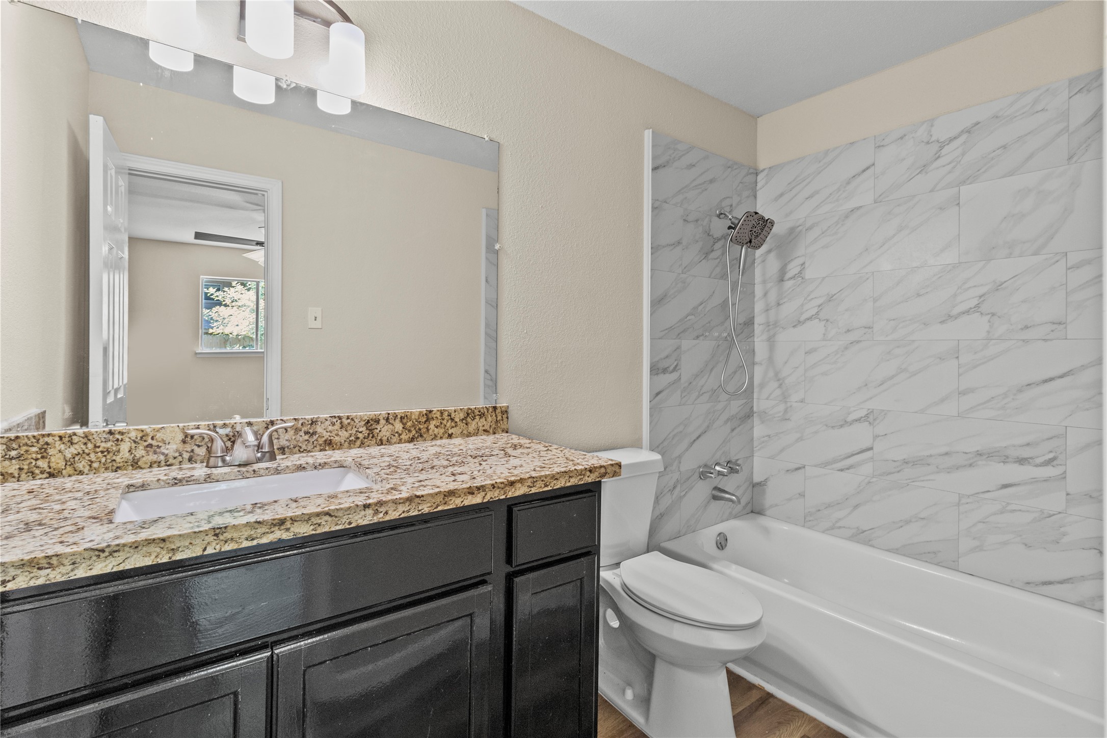 5026 Fitzwater Drive Spring, TX 77373 - Photo 14 of 14 The primary bathroom is modern with granite countertop, sleek black vanity, and marble-tiled shower. Bright and clean design.