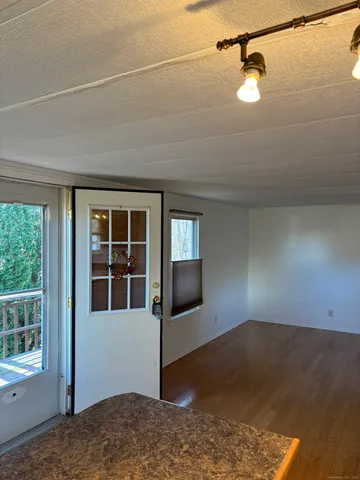 a view of a livingroom with wooden floor and a window