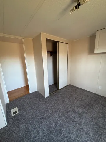 a view of an empty room with a fireplace