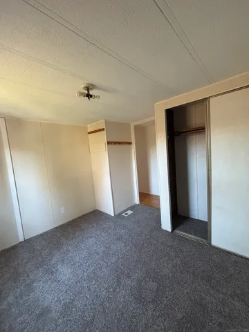 an empty room with closet and mirror