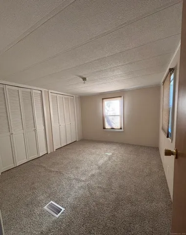 a view of an empty room and a window