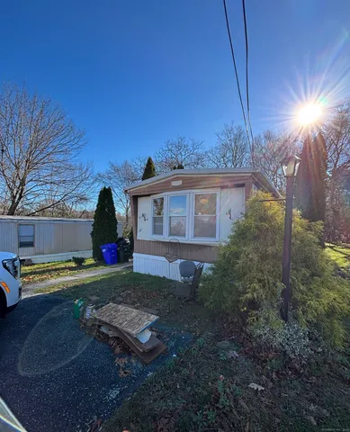 a view of a house with backyard and sitting area