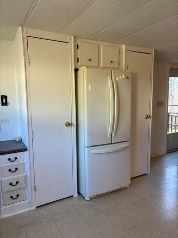 a bathroom with a refrigerator and a sink
