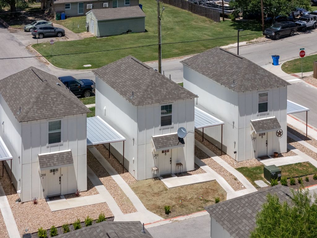 an aerial view of a house with a yard