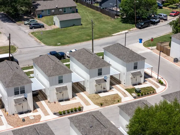 an aerial view of a house with swimming pool and patio