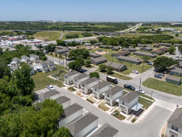 an aerial view of residential houses with outdoor space