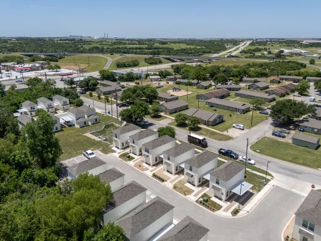 an aerial view of residential houses with outdoor space