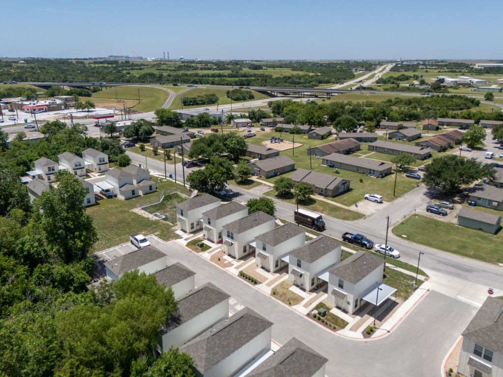 350 Debus Drive, Unit 205A Taylor, TX 76574 - Photo 3 of 9 an aerial view of residential houses with outdoor space