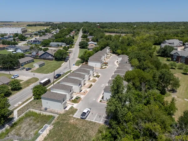 an aerial view of residential houses with outdoor space