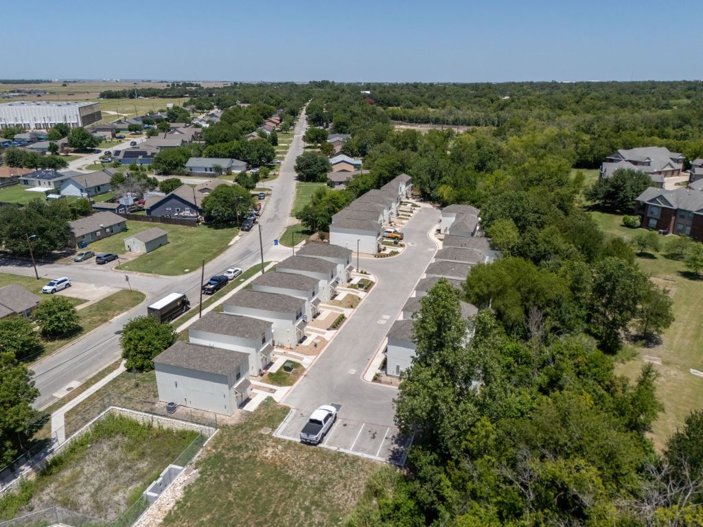 350 Debus Drive, Unit 205A Taylor, TX 76574 - Photo 4 of 9 an aerial view of residential houses with outdoor space