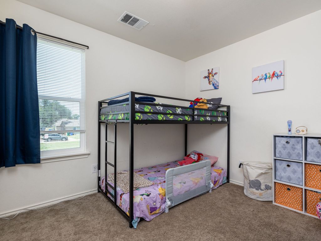 350 Debus Drive, Unit 205A Taylor, TX 76574 - Photo 6 of 9 a bedroom with a bed and a window
