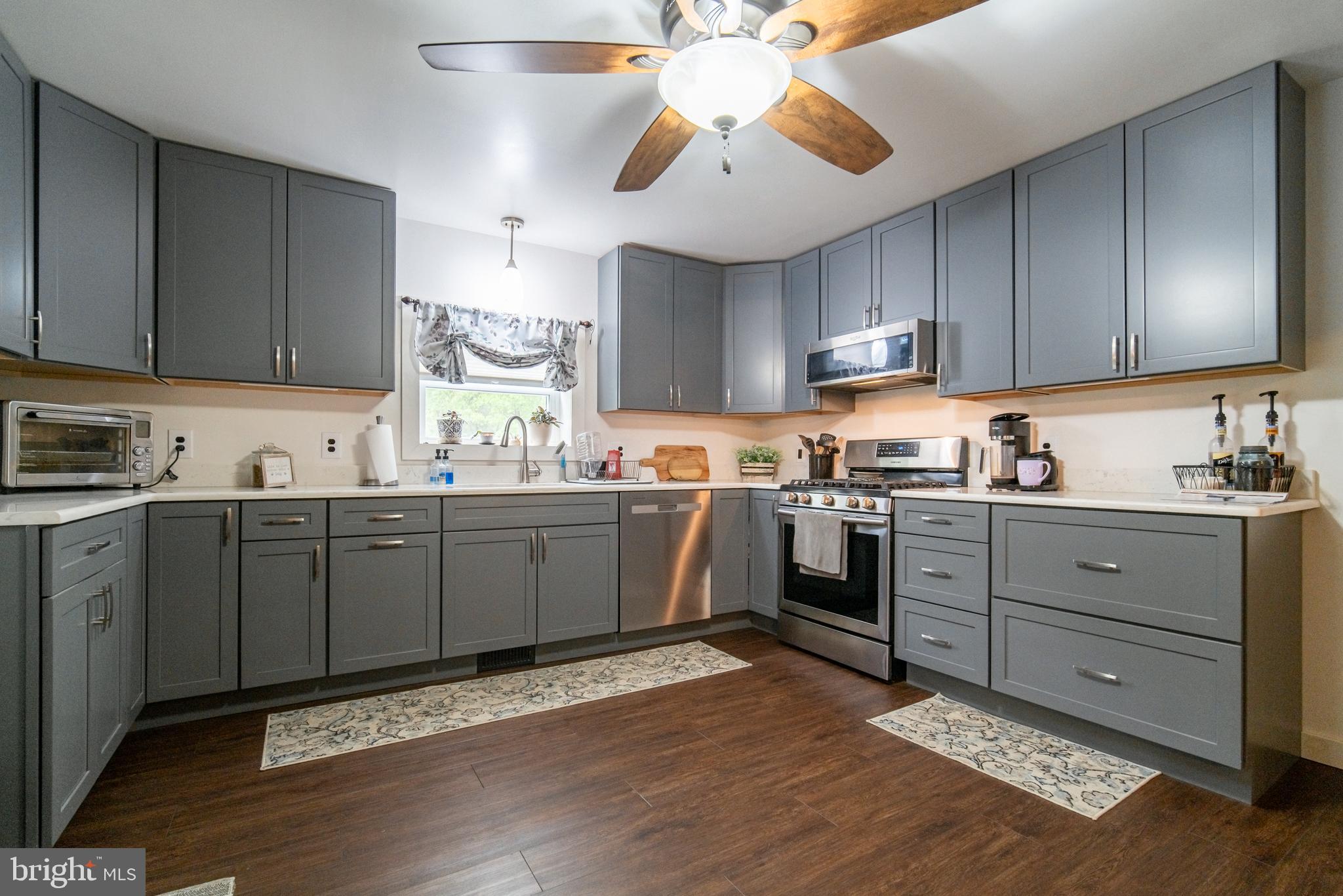 13127 Manor Furnace Road Brogue, PA 17309 - Photo 23 of 78 a kitchen with a stove window and cabinets