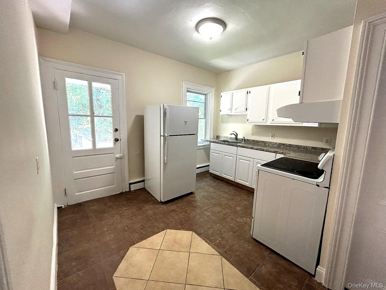 a kitchen with refrigerator and window
