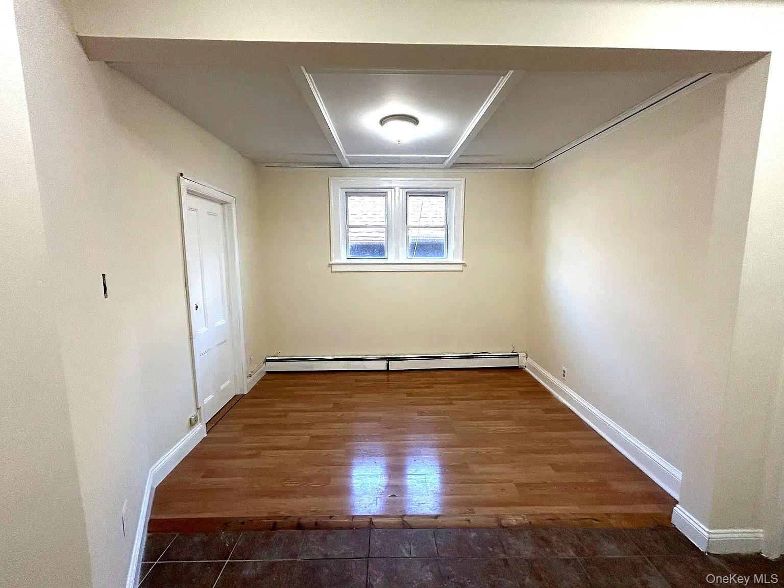 9 Grand Street, Unit 2 Poughkeepsie, NY 12601 - Photo 3 of 7 an empty room with wooden floor and windows