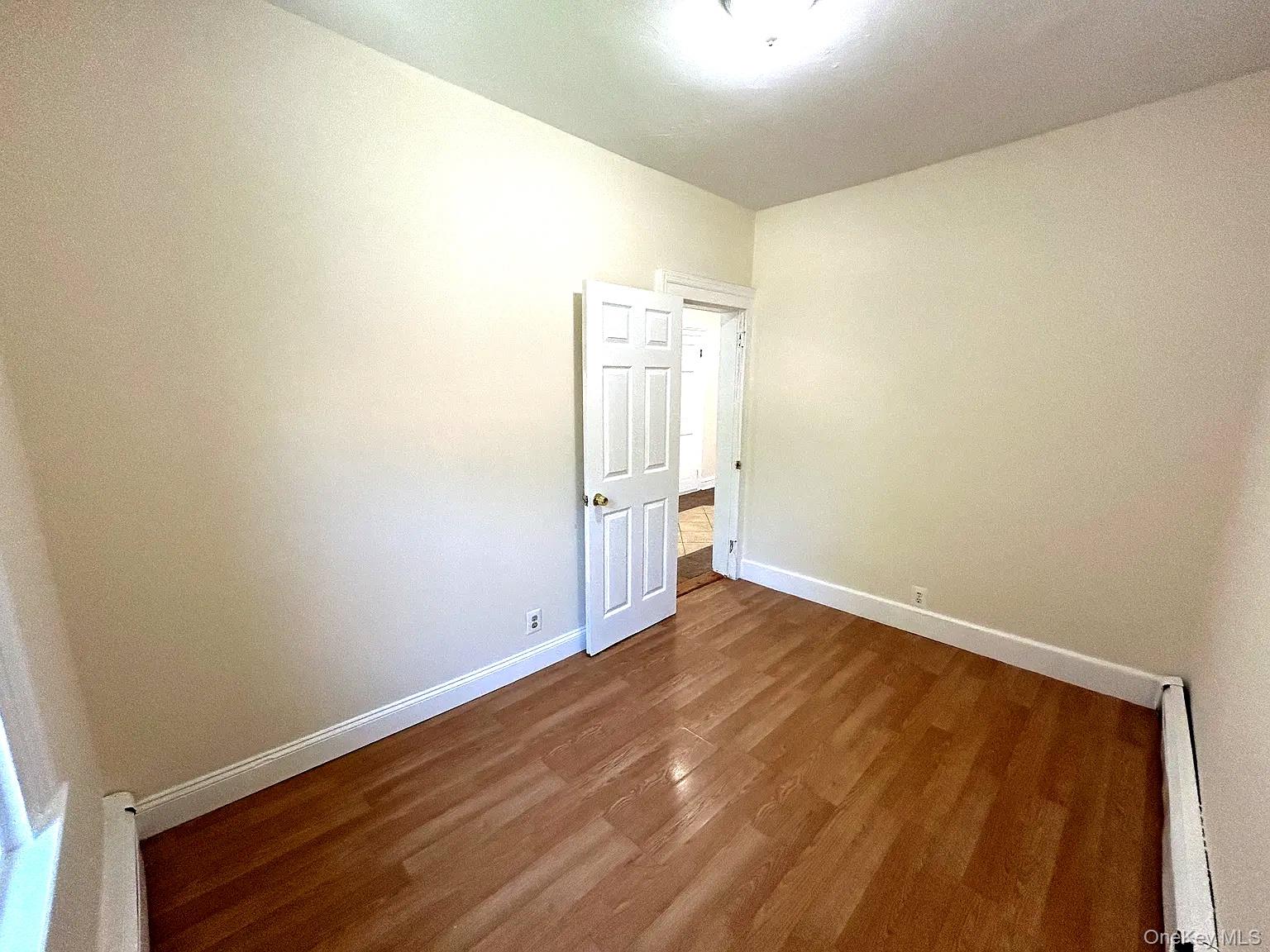 9 Grand Street, Unit 2 Poughkeepsie, NY 12601 - Photo 6 of 7 an empty room with wooden floor and windows