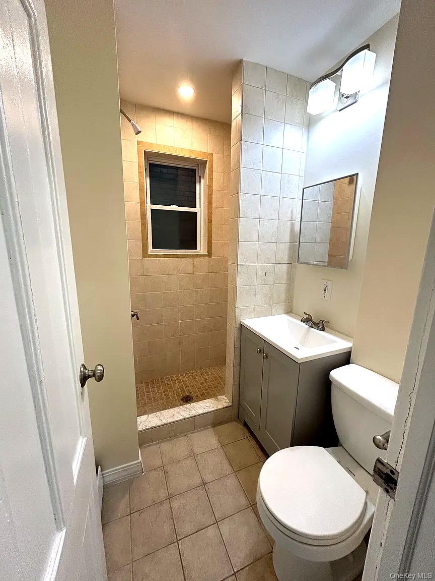 9 Grand Street, Unit 2 Poughkeepsie, NY 12601 - Photo 7 of 7 a white toilet sitting next to a bathroom sink