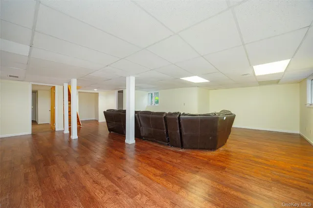 a living room with furniture and a hard wood floor
