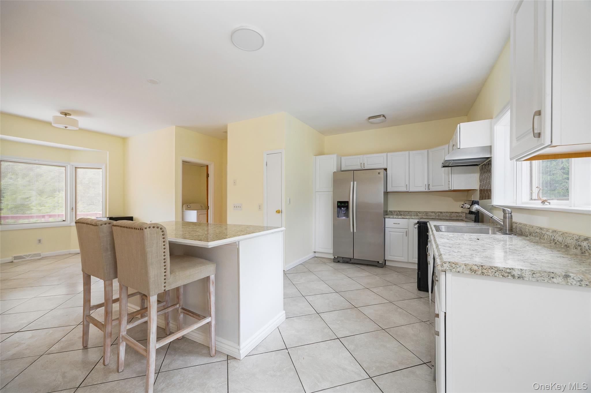 303 Freedom Road Pleasant Valley, NY 12569 - Photo 3 of 40 a kitchen with granite countertop a sink cabinets stainless steel appliances and a window